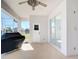 Enclosed lanai featuring neutral decor, a ceiling fan, and access to the backyard, perfect for outdoor relaxation at 4440 Tatum St, Port Charlotte, FL 33948