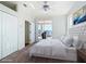 This staged main bedroom features wood floors, a ceiling fan, and sliding glass doors to a lanai at 4440 Tatum St, Port Charlotte, FL 33948