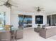 This covered patio features ceiling fans, outdoor furniture, and sliding glass doors with water views at 4440 Tatum St, Port Charlotte, FL 33948