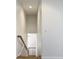 Interior shot of the staircase with wooden banister leading to the upper level at 4440 Tatum St, Port Charlotte, FL 33948