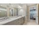 Bathroom featuring a double vanity with marble countertops, modern fixtures and tile flooring at 5066 Fairhope Cir, Bradenton, FL 34211