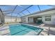 Private screened pool with tiled spa and seating area at 5066 Fairhope Cir, Bradenton, FL 34211