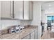 Kitchen with gray cabinets and granite countertops at 5226 Granite Dust Pl, Palmetto, FL 34221