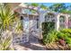 Ornate iron gates and a brick walkway lead to the front entrance at 5259 Villa Majorca Ct # 26, Sarasota, FL 34235