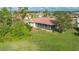 Aerial view of home with red tile roof and screened porch at 6602 Seven Pines Dr, Bradenton, FL 34203