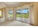 Bedroom with sliding glass doors and golf course view at 6602 Seven Pines Dr, Bradenton, FL 34203