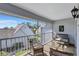 Relaxing screened balcony with wicker furniture, providing a comfortable outdoor living space with neighborhood views at 6713 Stone River Rd # 205, Bradenton, FL 34203