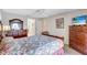 Bedroom with queen-size bed, wood dresser, and ceiling fan at 6713 Stone River Rd # 205, Bradenton, FL 34203