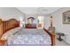 Main bedroom with king-size bed, wood dresser, and ceiling fan at 6713 Stone River Rd # 205, Bradenton, FL 34203