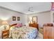 Bright bedroom with a floral comforter and wooden furniture at 6713 Stone River Rd # 205, Bradenton, FL 34203