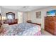 Bedroom with king-size bed and wood dresser at 6713 Stone River Rd # 205, Bradenton, FL 34203