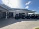 Community center with golf carts parked outside on a sunny day at 6713 Stone River Rd # 205, Bradenton, FL 34203