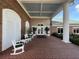 Brick clubhouse entrance with porch seating at 6713 Stone River Rd # 205, Bradenton, FL 34203