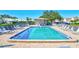 Inviting community pool with lounge chairs and patio area at 6713 Stone River Rd # 205, Bradenton, FL 34203