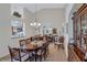 Elegant dining room with a large table and view into the kitchen at 6713 Stone River Rd # 205, Bradenton, FL 34203