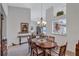 Bright dining room featuring a wood table and chairs, offering a view into the living room at 6713 Stone River Rd # 205, Bradenton, FL 34203