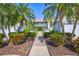 Pathway to condo unit with tropical landscaping at 6713 Stone River Rd # 205, Bradenton, FL 34203