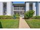Condo entrance with walkway, landscaping, and screened patio at 6713 Stone River Rd # 205, Bradenton, FL 34203