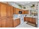 Bright kitchen with wood cabinets, white appliances, and floral wallpaper at 6713 Stone River Rd # 205, Bradenton, FL 34203