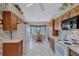 Full view of kitchen with wood cabinets and white appliances at 6713 Stone River Rd # 205, Bradenton, FL 34203