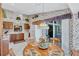 Kitchen with dining area, wood cabinets, and floral wallpaper at 6713 Stone River Rd # 205, Bradenton, FL 34203