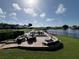 Relaxing patio area with lake view and seating at 6713 Stone River Rd # 205, Bradenton, FL 34203