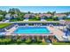 Community pool with surrounding lounge chairs and tables at 6713 Stone River Rd # 205, Bradenton, FL 34203