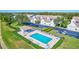 Community pool with lounge chairs and shaded area at 6713 Stone River Rd # 205, Bradenton, FL 34203