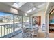 Bright sunroom with multiple windows and sliding glass doors, overlooking a golf course at 6713 Stone River Rd # 205, Bradenton, FL 34203