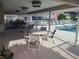 Relaxing poolside patio with tables and chairs at 6817 Fairview Ter # 24-101, Bradenton, FL 34203