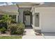 Front entry of a home with gray siding and white door at 716 46Th E St, Bradenton, FL 34208