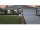 Gray house with white garage door, landscaping, and brick walkway at 716 46Th E St, Bradenton, FL 34208