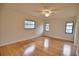 Bright bedroom with hardwood floors and two windows at 7171 Wood Creek Dr # 5, Sarasota, FL 34231