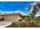 Tan one-story home with attached garage at 7171 Wood Creek Dr # 5, Sarasota, FL 34231