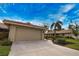 Tan one-story home with attached garage at 7171 Wood Creek Dr # 5, Sarasota, FL 34231