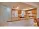 Kitchen features granite countertops, wood cabinets, and a breakfast bar at 7171 Wood Creek Dr # 5, Sarasota, FL 34231