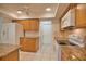 Kitchen features granite countertops and ample wood cabinetry at 7171 Wood Creek Dr # 5, Sarasota, FL 34231