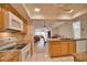 Kitchen with granite counters, wood cabinets, and views into living area at 7171 Wood Creek Dr # 5, Sarasota, FL 34231