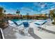 Community pool with blue lounge chairs and a surrounding fence at 7171 Wood Creek Dr # 5, Sarasota, FL 34231