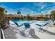 Community pool with blue lounge chairs and a surrounding fence at 7171 Wood Creek Dr # 5, Sarasota, FL 34231