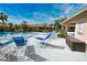 Community pool with blue lounge chairs and a surrounding fence at 7171 Wood Creek Dr # 5, Sarasota, FL 34231