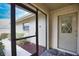 Screened entryway with tile floor leading to the front door at 7171 Wood Creek Dr # 5, Sarasota, FL 34231