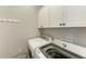 Convenient laundry room with washer, dryer, and cabinets at 7208 River Hammock Dr # 103, Bradenton, FL 34212