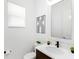 Powder room with modern vanity, single sink, and mirror at 741 Tailwind Pl, Sarasota, FL 34240