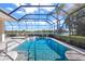 Resort-style pool and spa with screened enclosure and lake view at 7905 Royal Queensland Way, Lakewood Ranch, FL 34202