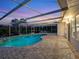 Refreshing kidney-shaped pool with screened enclosure and patio area at 7916 Midnight Pass Rd, Sarasota, FL 34242