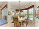 Bright breakfast nook with pool view, floral wallpaper, and a table for four at 10037 Cherry Hills Avenue Cir, Bradenton, FL 34202