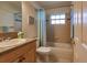 Cozy bathroom with tiled shower and a wooden vanity at 109 Tortuga Dr, Nokomis, FL 34275