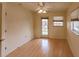 Bedroom with wood floors, ceiling fan, and sliding glass door to the outside at 109 Tortuga Dr, Nokomis, FL 34275