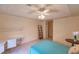 Bedroom featuring a ceiling fan, tiled floor, natural light, and built-in desk at 109 Tortuga Dr, Nokomis, FL 34275